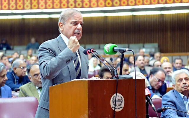 In this handout photograph taken and released by Pakistan's Press Information Department (PID) on November 12, 2025, Pakistan's Prime Minister Shehbaz Sharif addresses parliament session on constitutional amendmen (Photo by HANDOUT / Pakistan Press Information Department (PID) / AFP)