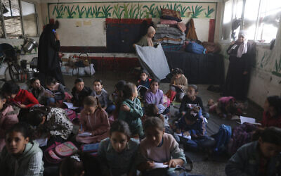 Palestinian children, many of whom are part of displaced families, sit on the floor as they attend class, at the UNRWA Deir al-Balah Joint School, west of Deir al-Balah, in the central Gaza Strip on December 6, 2025. (Photo by BASHAR TALEB / AFP) Palestinian children, many of whom are part of displaced families, sit on the floor as they attend class, at the UNRWA Deir al-Balah Joint School, west of Deir al-Balah, in the central Gaza Strip on December 6, 2025. (Photo by BASHAR TALEB / AFP)