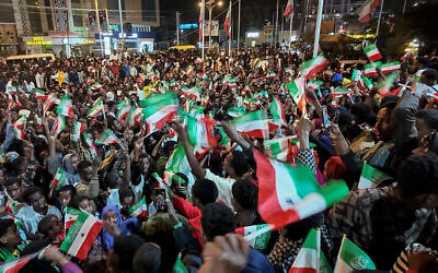 Residents wave Somaliland flags as they gather to celebrate Israel's recognition of Somaliland in downtown Hargeisa, December 26, 2025. (Farhan Aleli/AFP)