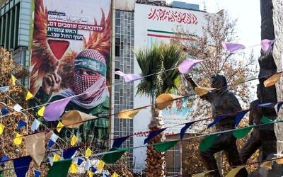 A large banner portraying an image of a Palestinian fighter and an anti-Israel slogan in Hebrew is erected in Palestine Square in Tehran, Iran, on December 31, 2025. (ATTA KENARE / AFP)