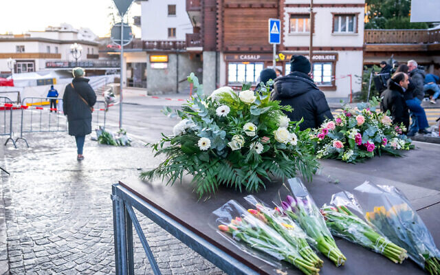Flowers are laid near the site where an fire ripped through a crowded bar in the Alpine ski resort town of Crans-Montana on January 1, 2026. (Maxime Schmid/AFP) Flowers are laid near the site where an fire ripped through a crowded bar in the Alpine ski resort town of Crans-Montana on January 1, 2026. (Maxime Schmid/AFP)