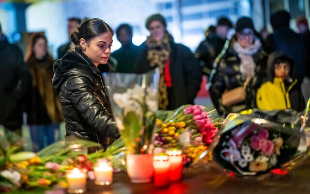 A woman lays flowers near the site where a fire ripped through a crowded bar during New Year's Eve celebrations in the Alpine ski resort town of Crans-Montana, Switzerland, on January 1, 2026. (MAXIME SCHMID / AFP) A woman lays flowers near the site where a fire ripped through a crowded bar during New Year's Eve celebrations in the Alpine ski resort town of Crans-Montana, Switzerland, on January 1, 2026. (MAXIME SCHMID / AFP)