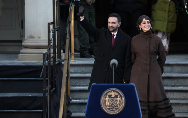 New York City Mayor Zohran Mamdani waves next to his wife, Rama Duwaji, during his public inauguration ceremony at City Hall in New York on January 1, 2026. (Angela Weiss/AFP)