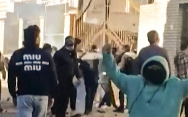 This grab taken on January 2, 2026, from UGC images posted on social media on December 31, 2025, shows protestors attacking a government building in Fasa, in southern Iran, on December 31, amid spontaneous nationwide protests driven by dissatisfaction at the country's economic stagnation. (Photo by UGC / AFP)