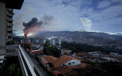 This grab taken on January 3, 2026, from UGC footage released by Jose Abreu on his X account @Jabreu89, shows smoke billowing over Caracas, Venezuela, after a series of explosions during a US military operation that led to the capture of Venezuelan President Nicolas Madruo. (Jose ABREU / @Jabreu89 / X / AFP)