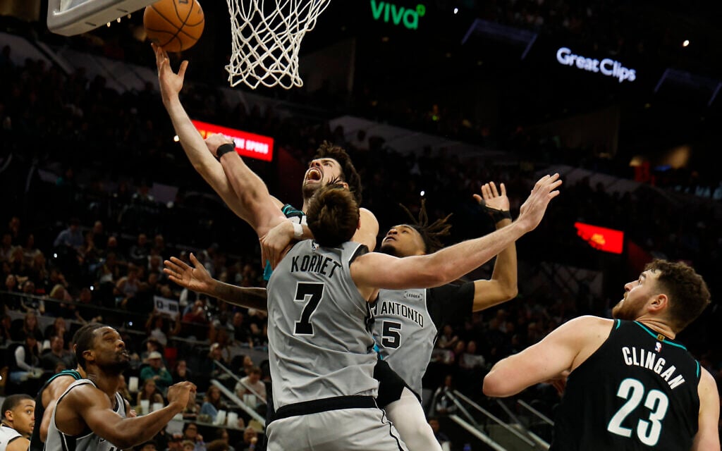 Deni Avdija of the Portland Trailblazers drives over Luke Kornet (#7) of the San Antonio Spurs in the second half at Frost Bank Center on January 3, 2026, in San Antonio, Texas. (Ronald Cortes / Getty Images via AFP) Deni Avdija of the Portland Trailblazers drives over Luke Kornet (#7) of the San Antonio Spurs in the second half at Frost Bank Center on January 3, 2026, in San Antonio, Texas. (Ronald Cortes / Getty Images via AFP)