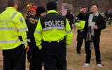 Jake Lang (right), who was charged with eight counts of assaulting officers on January 6, 2021, before his pardon, threatens DC Metropolitan Police officers during a rally and memorial march marking five years since the storming of the US Capitol, on January 6, 2026, in Washington, DC. (Chip Somodevilla/Getty Images/AFP)