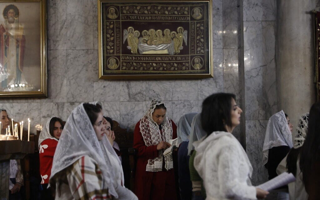 Worshippers attend a Christmas service at the Greek Orthodox Church of Saint Porphyrius in the Old City of Gaza City on January 7, 2026. (Omar AL-QATTAA / AFP)