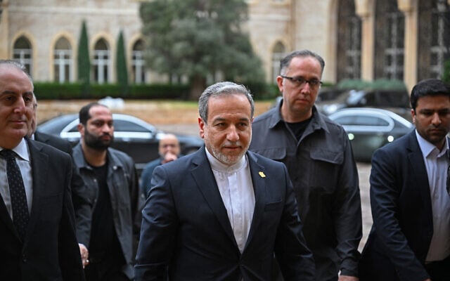 Iranian Foreign Minister Abbas Araghchi (C) arrives at the government palace to meet Lebanon's Prime Minister Nawaf Salam, in Beirut on January 9, 2026. (JOSEPH EID / AFP)