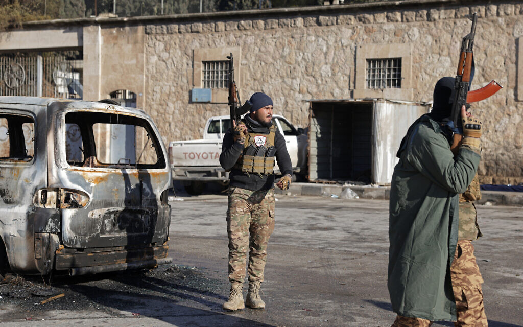Members of Syrian government security forces stand guard along a street in the Sheikh Maqsud neighborhood of Aleppo, on January 10, 2026. (Bakr ALkasem / AFP)