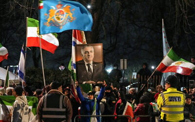Anti-Iranian regime protesters hold up a portrait the last shah of Iran, Reza Pahlavi, as they take part in a demonstration outside the Iranian Embassy in central London on January 10, 2026. (CARLOS JASSO / AFP)