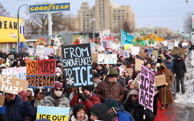 People walk through the streets to protest against ICE after the fatal shooting of Renee Nicole Good in Minneapolis, Minnesota on January 10, 2026. (CHARLY TRIBALLEAU / AFP)