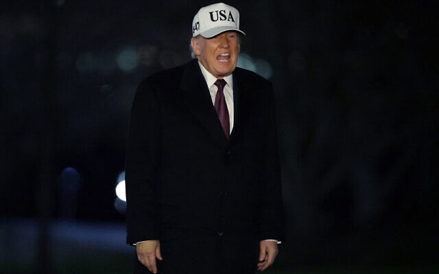 US President Donald Trump walks on the South Lawn after he landed at the White House on January 11, 2026, in Washington, DC. (Alex Wong/Getty Images/AFP)
