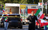 People walk near a U-Haul truck that reportedly was driven into a crowd during a rally against the Iranian regime on January 11, 2026, in Los Angeles, California. (Jonathan Alcorn/AFP)
