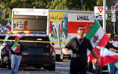 People walk near a U-Haul truck that reportedly was driven into a crowd during a rally against the Iranian regime on January 11, 2026, in Los Angeles, California. (Jonathan Alcorn/AFP)