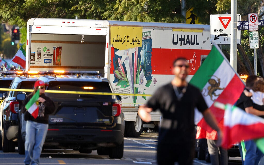People walk near a U-Haul truck that reportedly was driven into a crowd during an anti-Iranian regime rally on January 11, 2026, in Los Angeles, California. (Jonathan Alcorn / AFP)