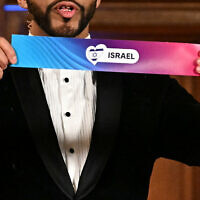 Moderator Austrian singer Cesar Sampson holds a draw for Israel during the draw session for the Eurovision Song Contest 2026 on stage at the Vienna's city hall in Vienna, Austria, on January 12, 2026. (Joe Klamar / AFP)