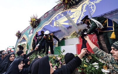 Iranians attend the funerals of security personnel killed in protests in Tehran on January 14, 2026. (ATTA KENARE / AFP)