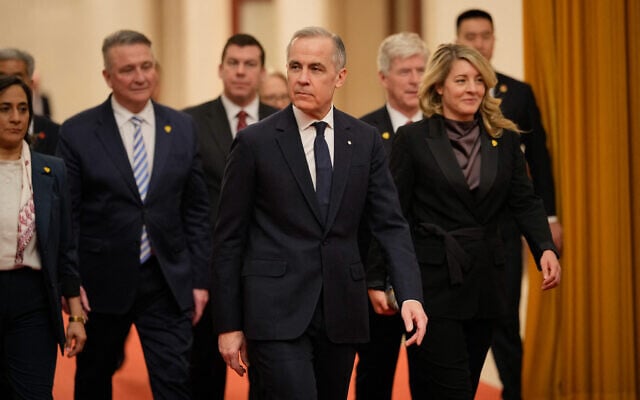 Canada's Prime Minister Mark Carney (C) arrives for meeting with Chinese President Xi Jinping at the Great Hall of the People in Beijing on January 16, 2026. (Vincent Thian / Pool / AFP)