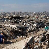 Displaced Palestinians walk amongst the rubble in the Jabalia refugee camp, in the northern Gaza Strip on January 17, 2026. (Omar AL-QATTAA / AFP)