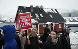 Young people with placards reading 'Greenland is not for sale!' take part in a demonstration that gathered almost a third of the city population to protest against the US president's plans to take Greenland, on January 17, 2026 in Nuuk, Greenland, near the US Consulate to Greenland. (Alessandro RAMPAZZO / AFP)