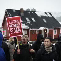 Young people with placards reading 'Greenland is not for sale!' take part in a demonstration that gathered almost a third of the city population to protest against the US president's plans to take Greenland, on January 17, 2026 in Nuuk, Greenland, near the US Consulate to Greenland. (Alessandro RAMPAZZO / AFP)