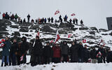 People wave Greenlandic flags as they take part in a demonstration against the US President's plans to take Greenland, on January 17, 2026 in Nuuk, Greenland (Alessandro RAMPAZZO / AFP)