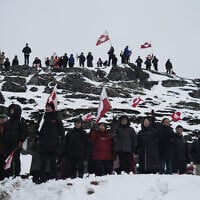 People wave Greenlandic flags as they take part in a demonstration against the US President's plans to take Greenland, on January 17, 2026 in Nuuk, Greenland (Alessandro RAMPAZZO / AFP)