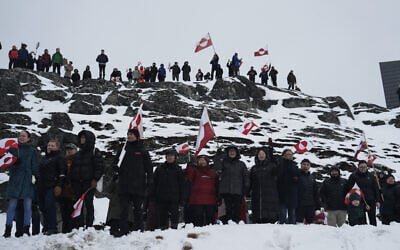 People wave Greenlandic flags as they take part in a demonstration against the US President's plans to take Greenland, on January 17, 2026 in Nuuk, Greenland (Alessandro RAMPAZZO / AFP)