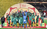 Senegal's forward #10 Sadio Mane holds up the trophy as he celebrates with his teammates after winning the Africa Cup of Nations (CAN) final soccer match against Morocco at the Prince Moulay Abdellah Stadium, in Rabat, Morocco, on January 18, 2026. (SEBASTIEN BOZON / AFP)