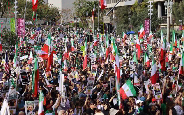 Demonstrators hold flags and placards during a rally in solidarity with protesters in Iran, in Los Angeles, California, on January 18, 2026. (Jonathan Alcorn / AFP)