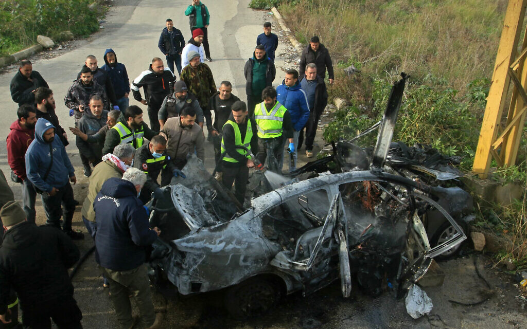 First aid responders inspect the wreckage of a car at the site of an Israeli airstrike in the southern Lebanon area of Zahrani on January 21, 2026.(Mahmoud Zayyat/AFP)