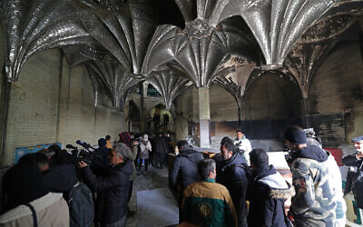 This photograph taken during a tour for foreign media shows media representatives visiting the Al-Aqsa Mosque that was damaged during recent public protests in Tehran, January 21, 2026. (ATTA KENARE / AFP)