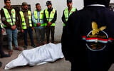 Palestinian employees working for the Egyptian Committee for Gaza Relief gather around a body bag carrying two bodies at Nasser Hospital in Gaza City on January 21, 2026. (Omar AL-QATTAA / AFP)