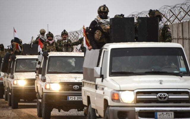 Members of the Iraqi Popular Mobilization Forces drive along the border with Syria in the Tarfawi area of northwestern Iraq on January 22, 2026. (Zaid AL-OBEIDI / AFP) Members of the Iraqi Popular Mobilization Forces drive along the border with Syria in the Tarfawi area of northwestern Iraq on January 22, 2026. (Zaid AL-OBEIDI / AFP)