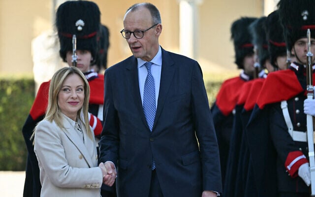 Italian Prime Minister Giorgia Meloni and German Chancellor Friedrich Merz shake hands after reviewing an honor guard before an intergovernmental summit between Italy and Germany, at Villa Doria Pamphilj in Rome on January 23, 2026. (Andreas Solaro/AFP) Italian Prime Minister Giorgia Meloni and German Chancellor Friedrich Merz shake hands after reviewing an honor guard before an intergovernmental summit between Italy and Germany, at Villa Doria Pamphilj in Rome on January 23, 2026. (Andreas Solaro/AFP)