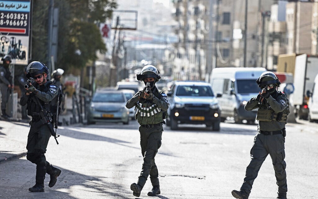 Members of Israeli security forces patrol along a street during a military raid in the neighbourhood of Kafr Aqab near Ramallah, West Bank on January 26, 2026. (Zain JAAFAR / AFP)