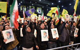 Hezbollah supporters chant slogans while holding portraits of Iran's Supreme Leader Ayatollah Ali Khamenei during a rally to show their solidarity with Iran, in the southern suburb of Beirut on January 26, 2026. (Anwar AMRO / AFP)
