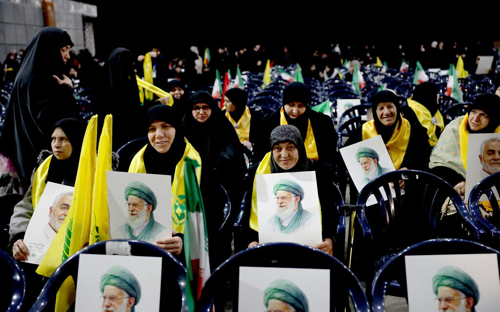 Hezbollah supporters hold portraits of Iran's Supreme Leader Ayatollah Ali Khamenei during a rally to show their solidarity with Iran, in the southern suburb of Beirut on January 26, 2026.  (Photo by Anwar AMRO / AFP)