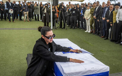 Shira Gvili, sister of Israeli hostage Ran Gvili, whose remains were finally brought back to Israel on January 26, reacts by the casket during his funeral in the southern town of Meitar on January 28, 2026. (Chaim Goldberg / POOL / AFP)