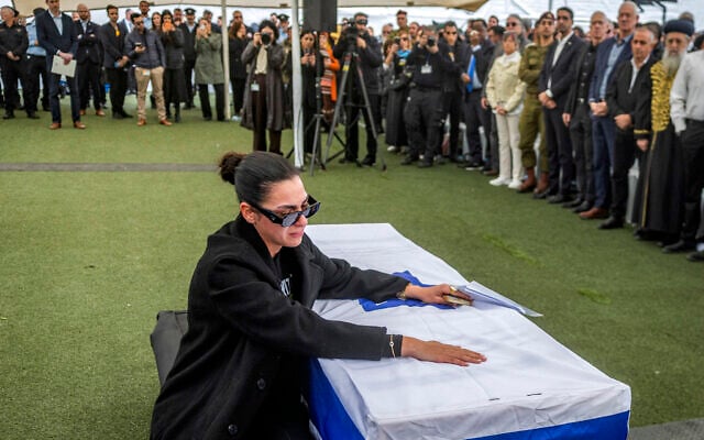 Shira Gvili, sister of Israeli hostage Ran Gvili, whose remains were finally brought back to Israel on January 26, reacts by the casket during his funeral in the southern town of Meitar on January 28, 2026. (Chaim Goldberg / POOL / AFP)