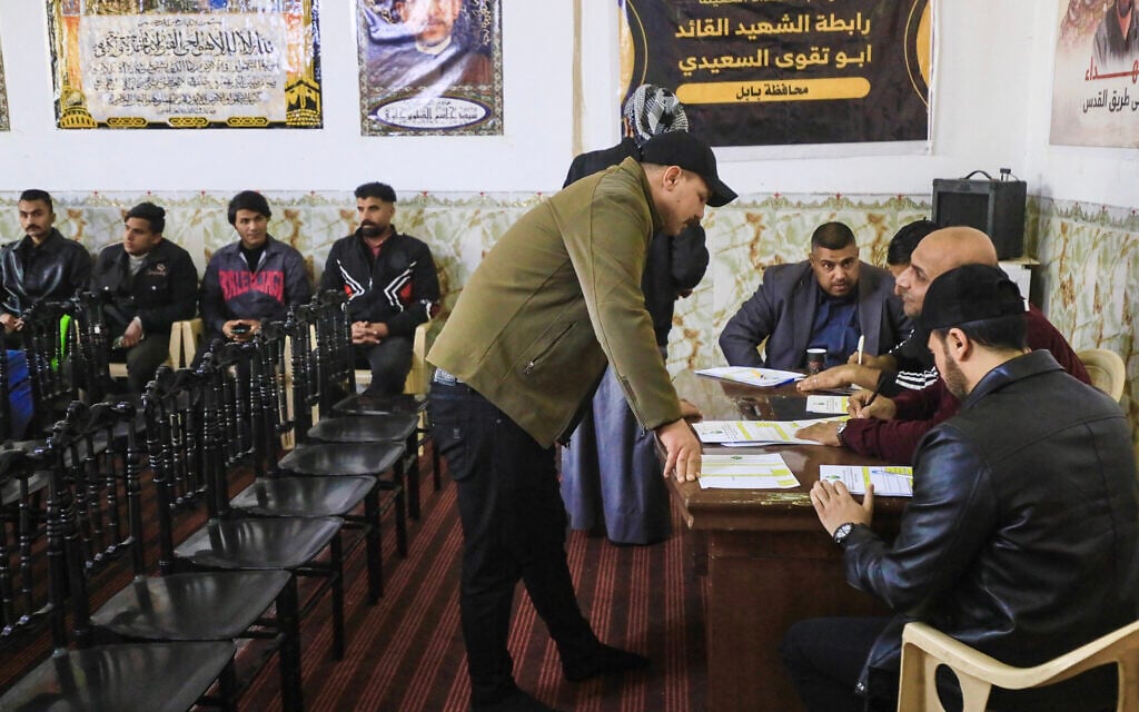 A man registers to join the so-called Martyrs Brigades under the umbrella of Iraq's pro-Iran armed group Harakat al-Nujaba, which called on Iraqis to volunteer to fight alongside Iran in the event of a full-scale war with the United States and Israel, in Hillah on January 30, 2026. (Karrar Jabbar / AFP)