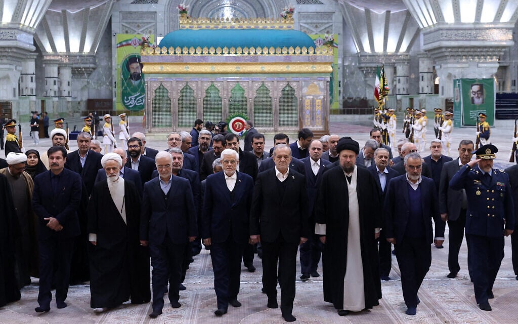 Iran's President Masoud Pezeshkian (C), accompanied by Hasan Khomeni (R), the grandson of late supreme leader Ayatollah Ruhollah Khomeini and cabinet members, visit of the tomb of Khomeini, in Tehran on January 31, 2026, ahead of the 47th anniversary of the 1979 Islamic Revolution. (Handout / Iranian Presidency / AFP)