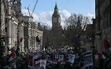 Protesters hold placards and wave Palestinian flags during a pro-Palestine protest in central London on January 31, 2026. (JUSTIN TALLIS / AFP)