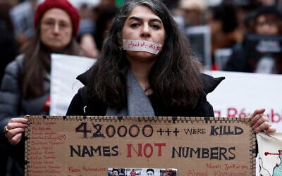 A demonstrator wears a sticker over her mouth with the words "no execution" during a silent march denouncing the Iranian government's deadly crackdown on anti-government protesters in the Islamic Republic, in Paris on January 31, 2026. (Sébastien DUPUY / AFP)