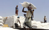 Men deliver UN World Food Program (WFP) aid in Aslam, Hajjah, Yemen, September 21, 2018.  (Hammadi Issa/AP)