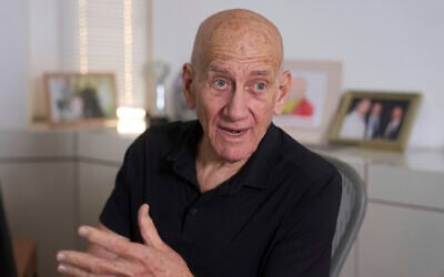 Former prime minister Ehud Olmert speaks during an interview with The Associated Press in his office in Tel Aviv on May 22, 2025. (Ariel Schalit/AP)
