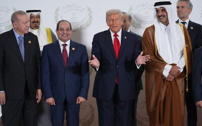 US President Donald Trump gestures during a photo during a summit to support ending the more than two-year Israel-Hamas war in Gaza after a breakthrough ceasefire deal, Monday, Oct. 13, 2025, in Sharm El Sheikh, Egypt, as Turkey's President Recep Tayyip Erdogan, Egypt's President Abdel-Fattah el-Sissi and Emir of Qatar Tamim bin Hamad Al Thani watch. In back are the Emir of Kuwait Sheikh Meshal Al Ahmad Al Sabah, Pakistan's Prime Minister Shehbaz Sharif and Netherland's Prime Minister Dick Schoof. (AP Photo/Evan Vucci, Pool)