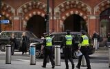 FILE: Police officers patrol the King's Cross train station, in London, November 3, 2025. (AP Photo/Kin Cheung)