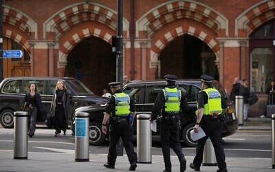 FILE: Police officers patrol the King's Cross train station, in London, November 3, 2025. (AP Photo/Kin Cheung)
